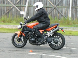 Squeeze the front brake progressively, but fully while at the same time easing off the rear brake to prevent a rear tire skid. 