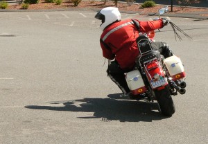 Hanging off the inside of the bike helps increase clearance.