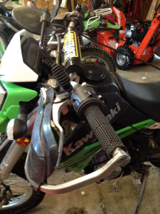 dual sport grips, Pro taper handlebar, and folding mirror.